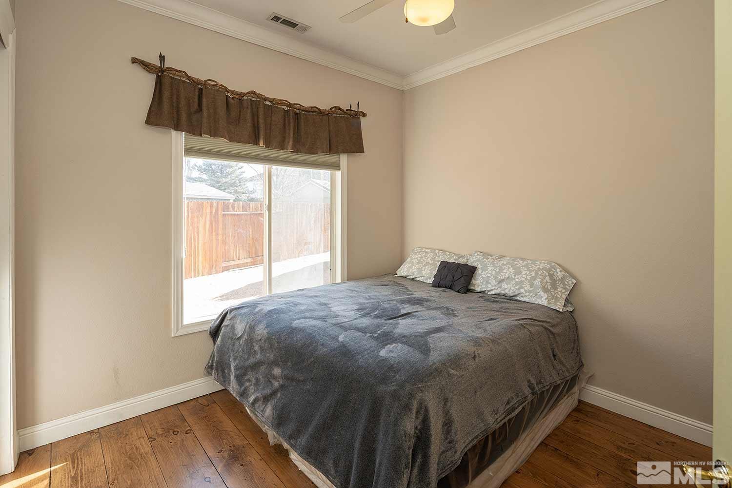 9785 Rolling Rock Court Reno, NV 89521 - Photo 23 of 35 a bedroom with a bed and window