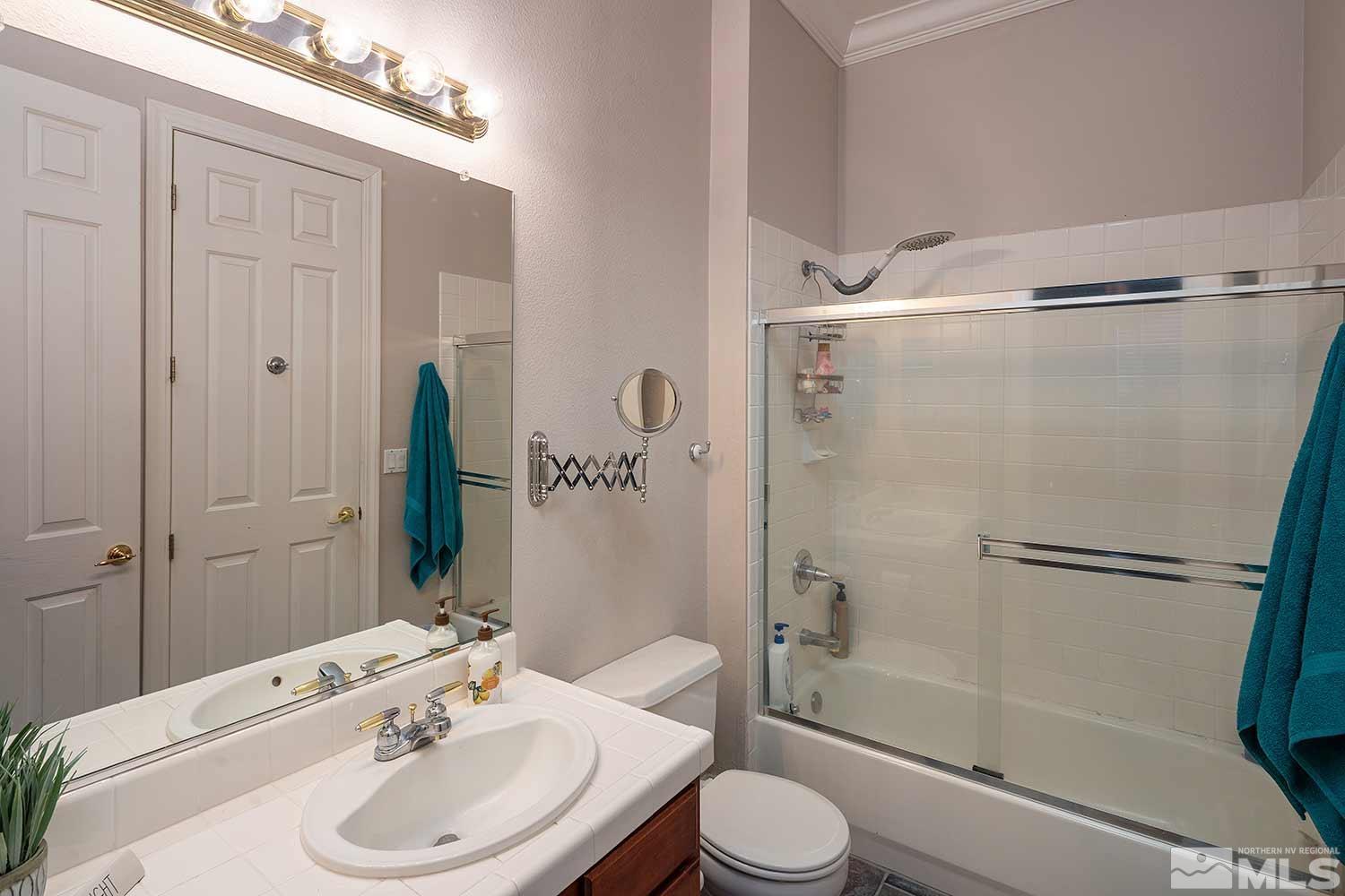 9785 Rolling Rock Court Reno, NV 89521 - Photo 25 of 35 a bathroom with a sink toilet and shower