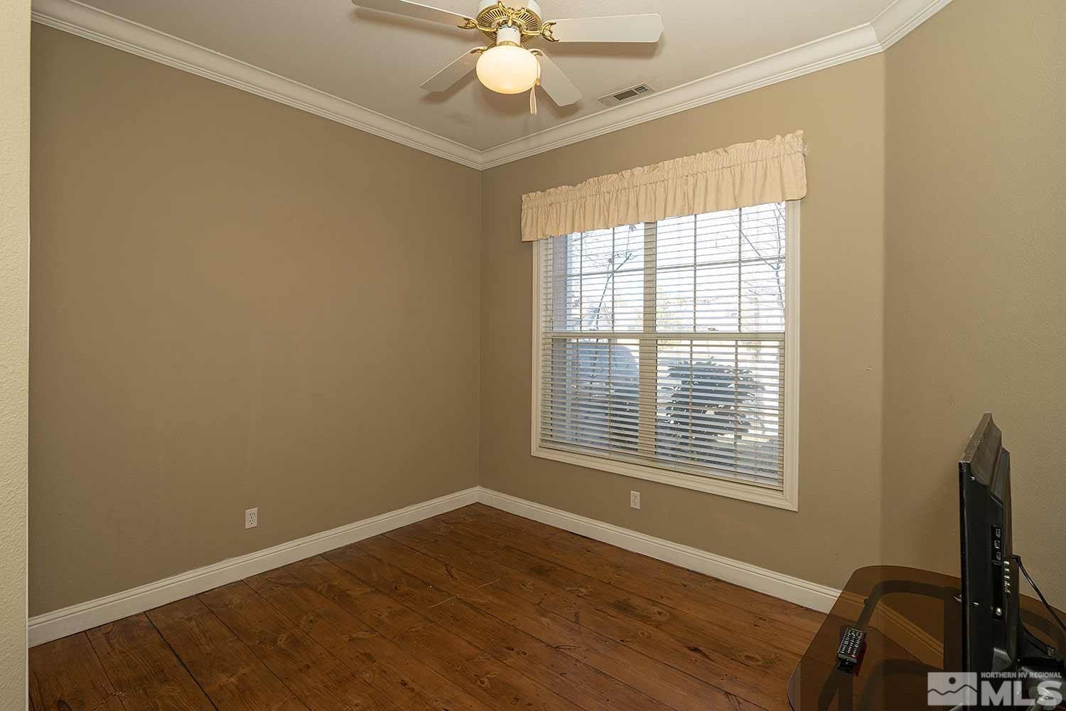 9785 Rolling Rock Court Reno, NV 89521 - Photo 26 of 35 a view of a workspace with wooden floor and a window
