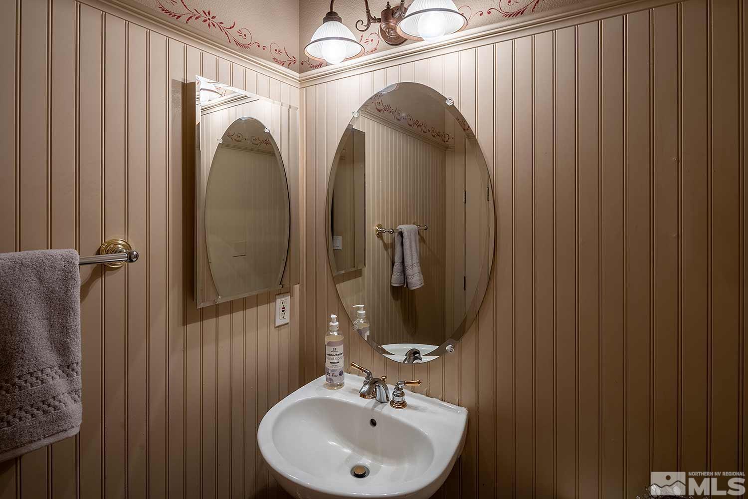 9785 Rolling Rock Court Reno, NV 89521 - Photo 27 of 35 a bathroom with a sink a mirror and shower