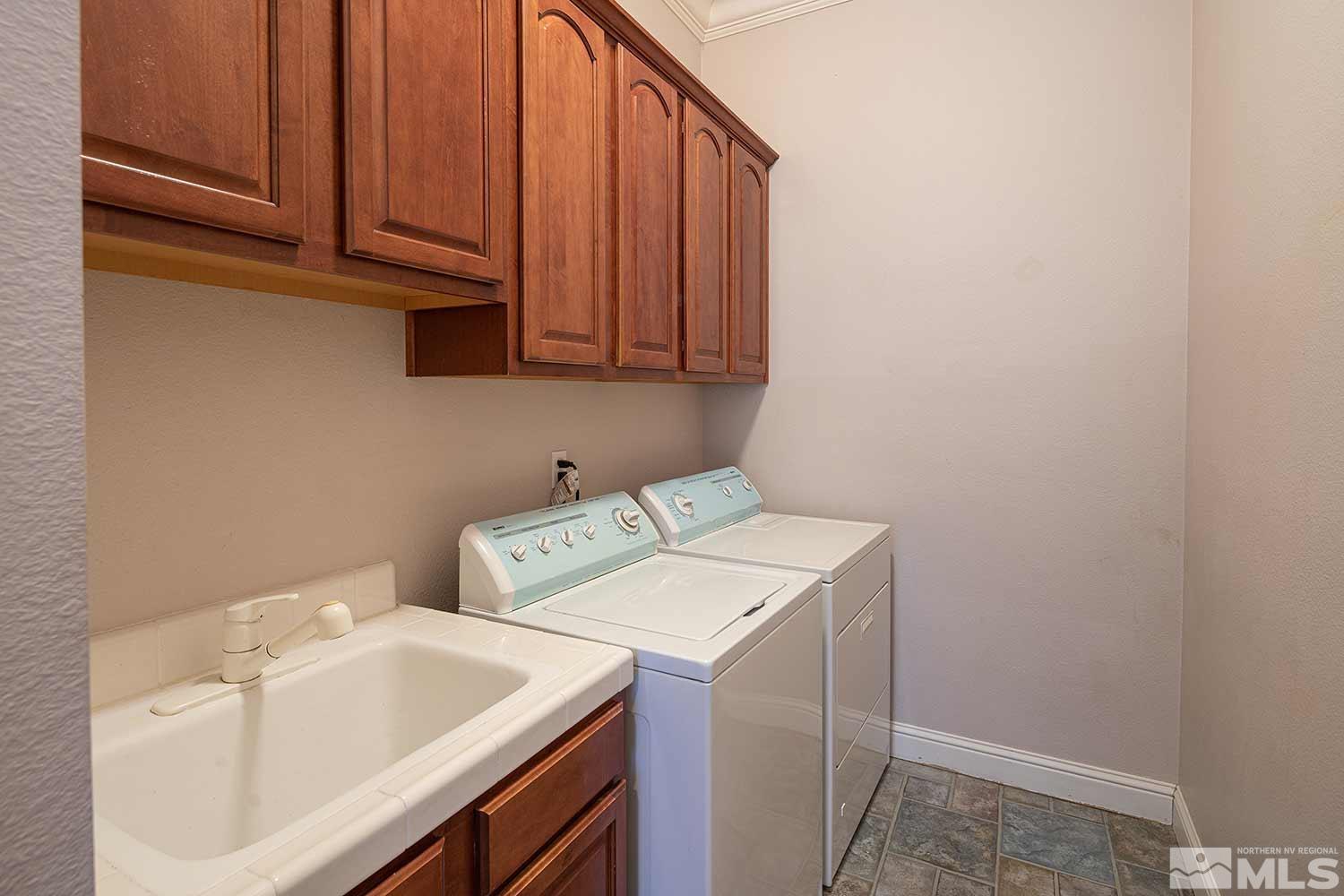 9785 Rolling Rock Court Reno, NV 89521 - Photo 28 of 35 a utility room with dryer and washer