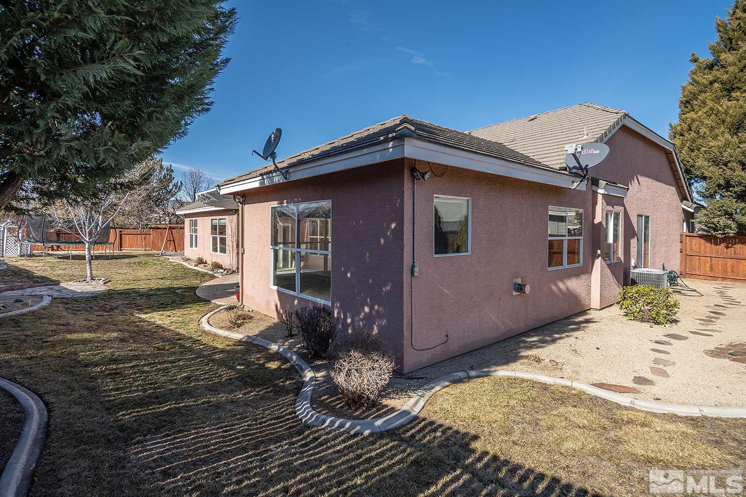9785 Rolling Rock Court Reno, NV 89521 - Photo 33 of 35 a front view of a house with a yard