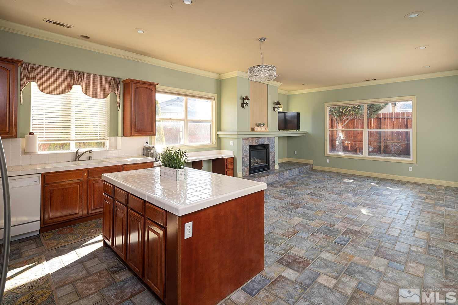 9785 Rolling Rock Court Reno, NV 89521 - Photo 6 of 35 a kitchen with a stove a sink a refrigerator and a granite counter top