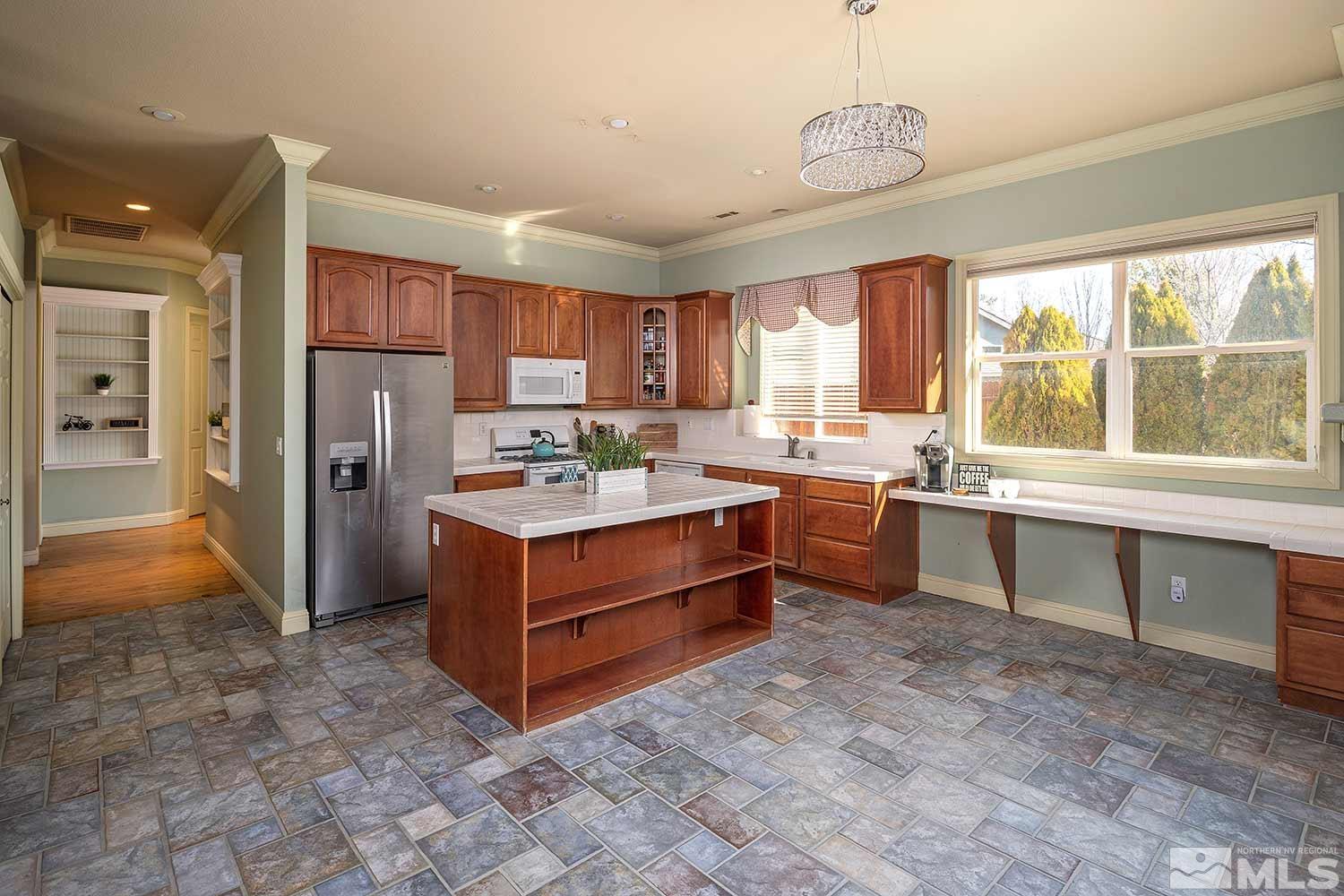 9785 Rolling Rock Court Reno, NV 89521 - Photo 9 of 35 a kitchen with a refrigerator sink and cabinets