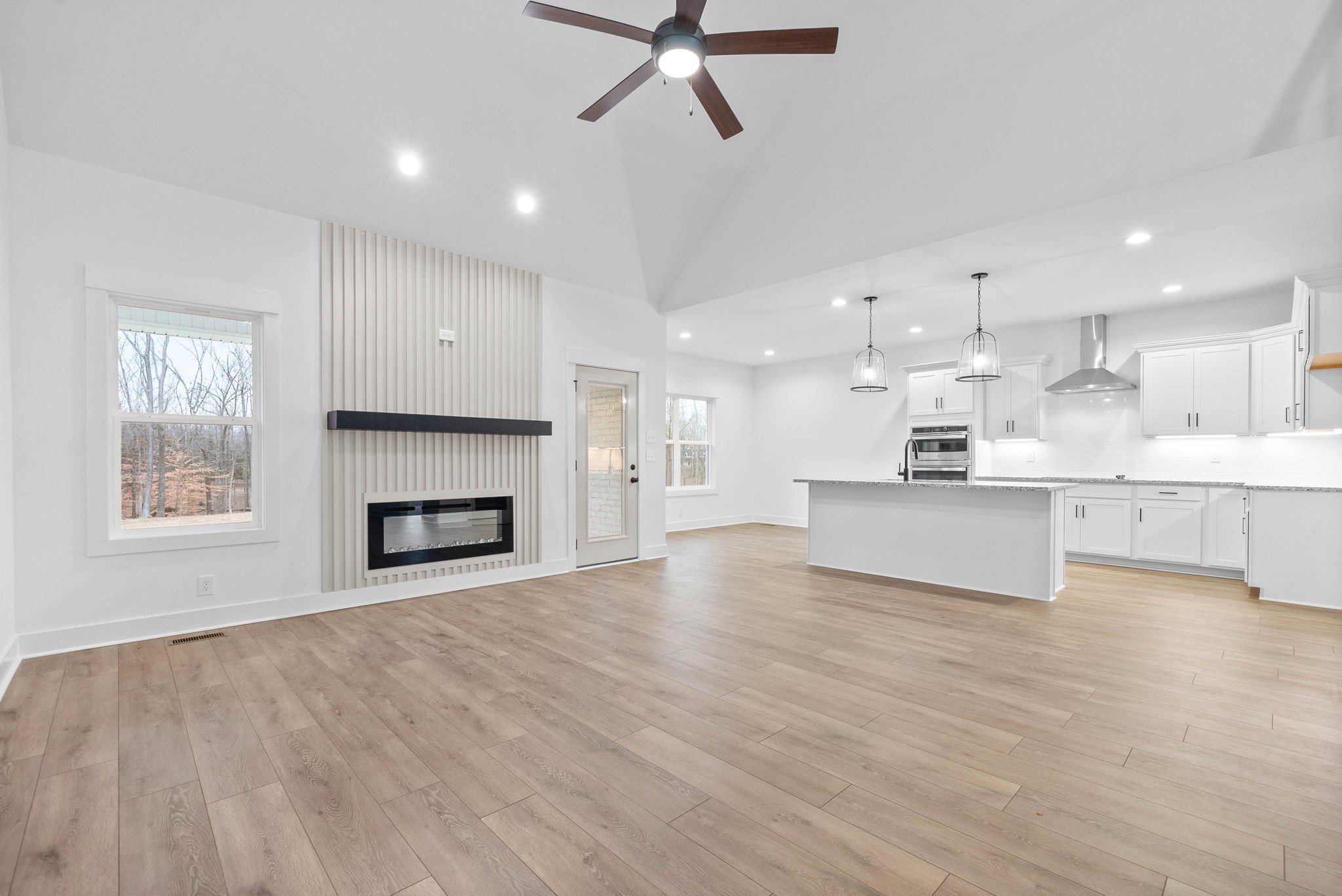 1360 Reda Drive Clarksville, TN 37042 - Photo 10 of 41 a view of an empty room and kitchen with fireplace wooden floor