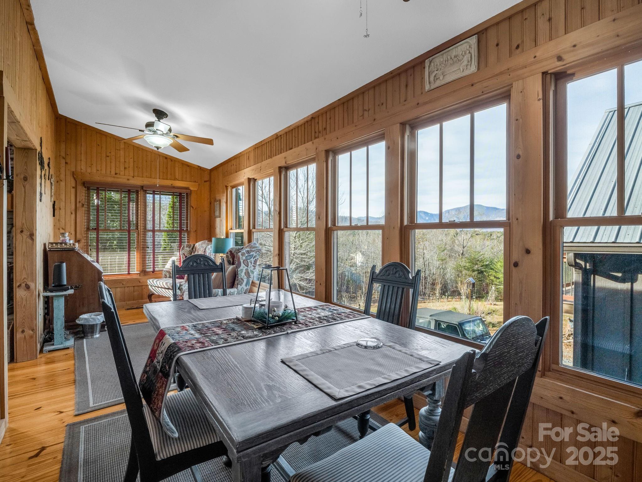 301 Peaks Drive Lake Lure, NC 28746 - Photo 16 of 48 a view of a dining room with furniture large windows and wooden floor