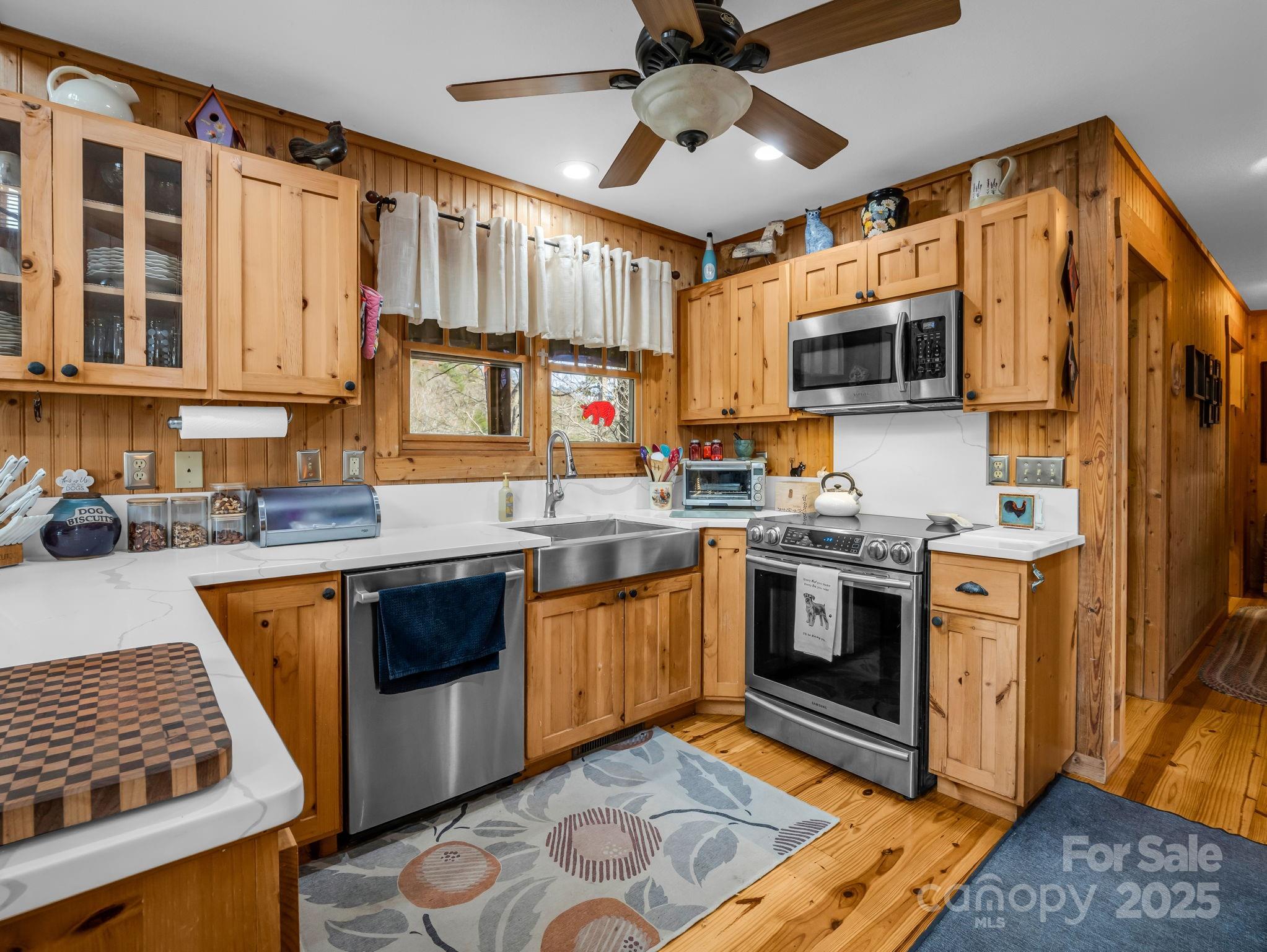 301 Peaks Drive Lake Lure, NC 28746 - Photo 18 of 48 a kitchen with stainless steel appliances granite countertop a stove top oven a sink dishwasher and a microwave oven on the blue kitchen countertops