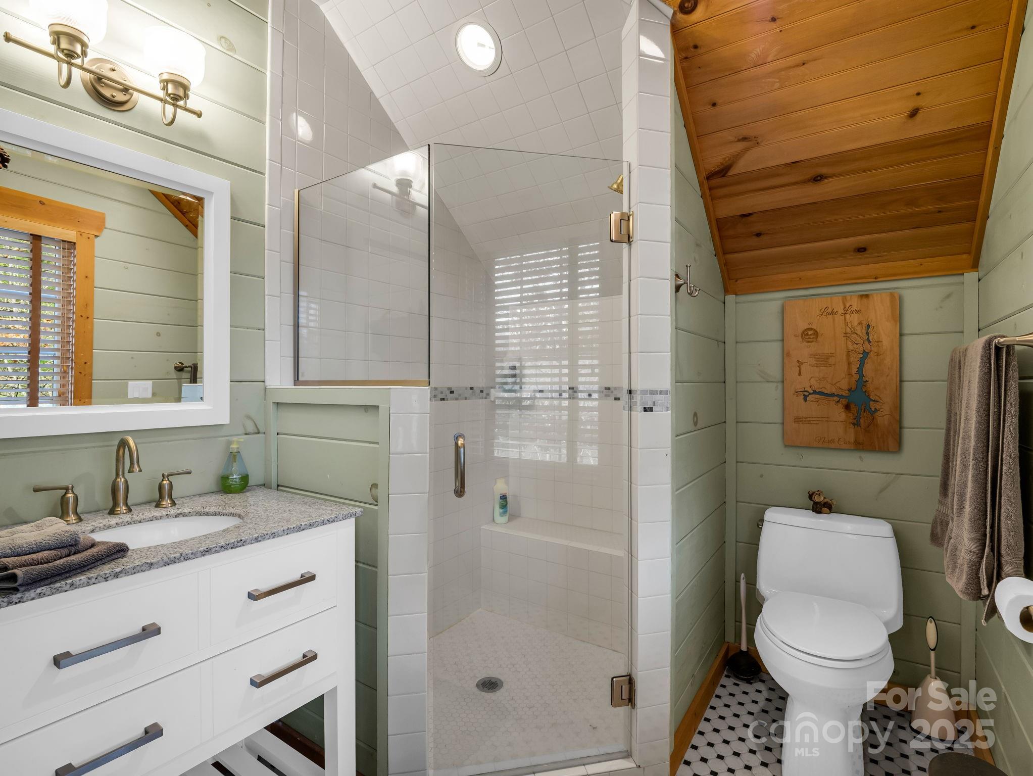 301 Peaks Drive Lake Lure, NC 28746 - Photo 21 of 48 a bathroom with a granite countertop sink toilet and shower