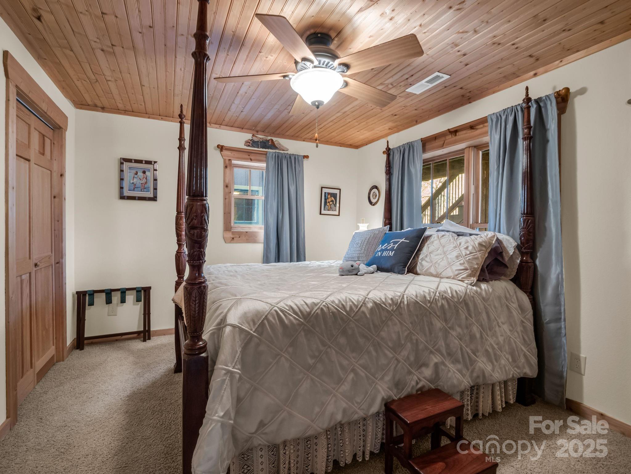 301 Peaks Drive Lake Lure, NC 28746 - Photo 29 of 48 a bed sitting in a spacious bedroom next to a window