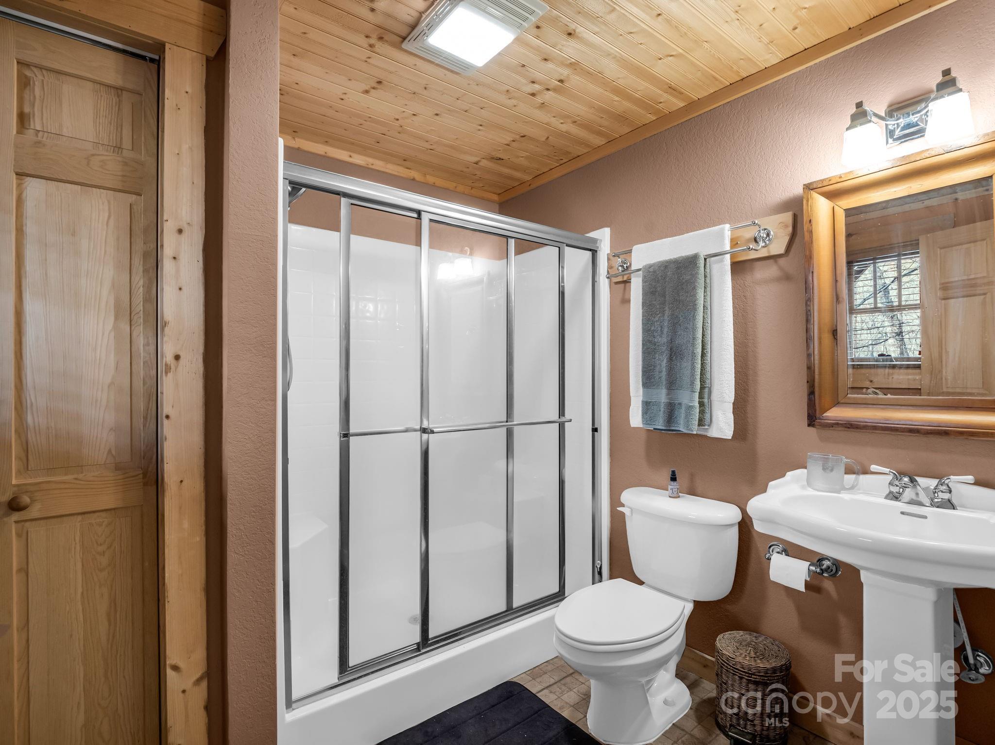 301 Peaks Drive Lake Lure, NC 28746 - Photo 30 of 48 a bathroom with a sink toilet and shower