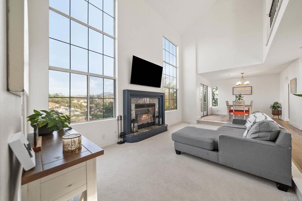 3863 Settineri Lane Spring Valley, CA 91977 - Photo 1 of 39 a living room with furniture a flat screen tv and a fireplace