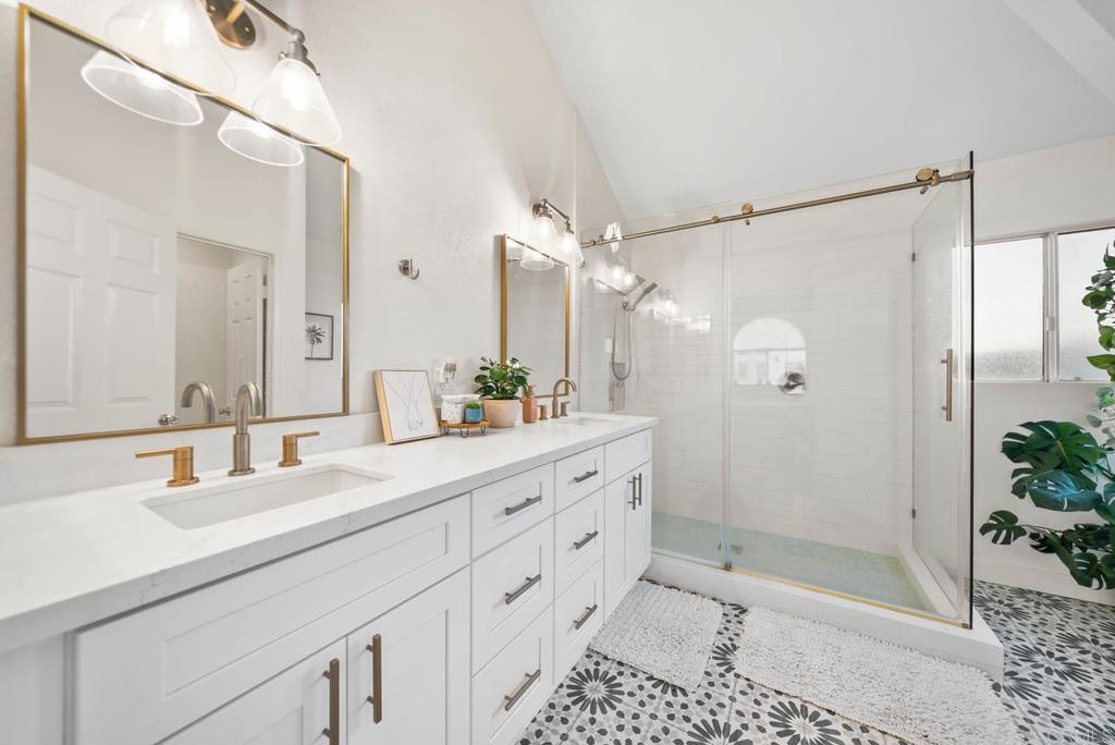 3863 Settineri Lane Spring Valley, CA 91977 - Photo 20 of 39 a bathroom with a double vanity sink mirror double shower and a bathtub