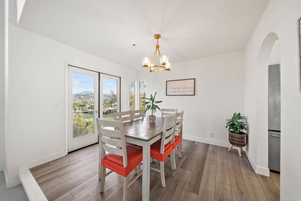 3863 Settineri Lane Spring Valley, CA 91977 - Photo 2 of 39 a dining room with furniture potted plants and wooden floor