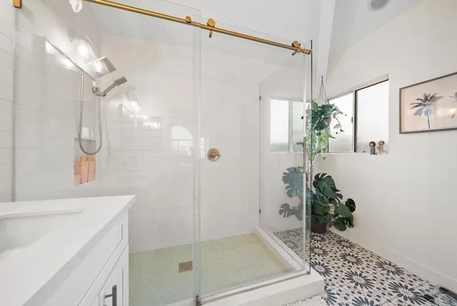 a bathroom with a shower and a sink