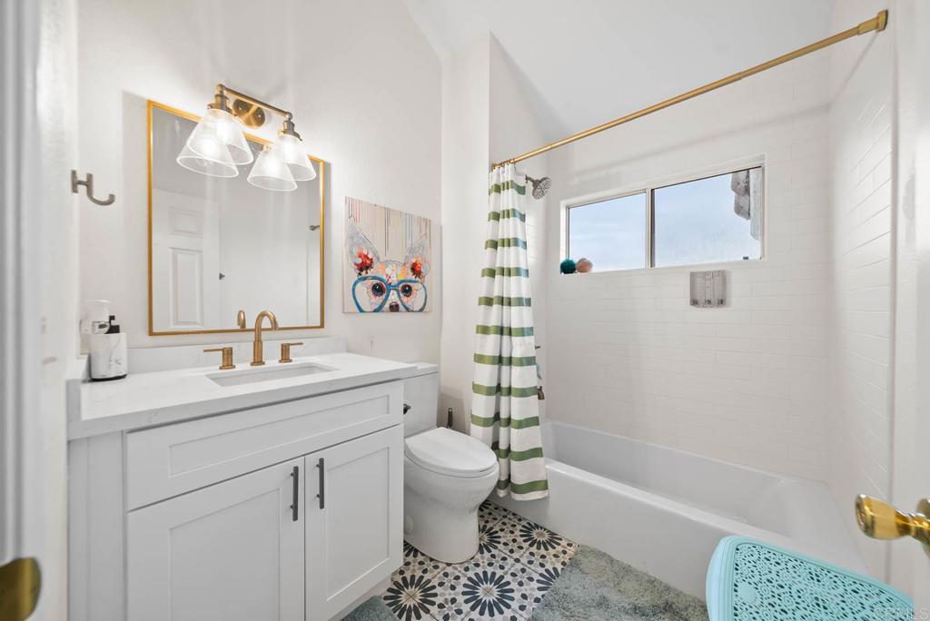 3863 Settineri Lane Spring Valley, CA 91977 - Photo 22 of 39 a bathroom with a sink a toilet and shower