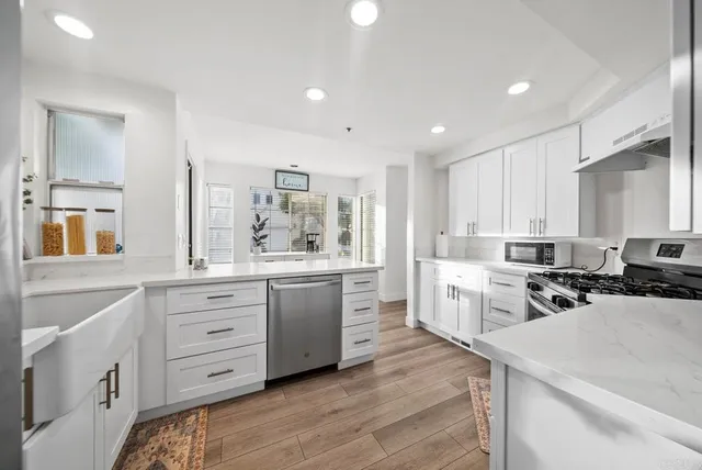 a kitchen with a stove a sink and a refrigerator