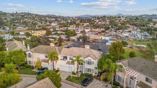 an aerial view of residential houses with outdoor space and river