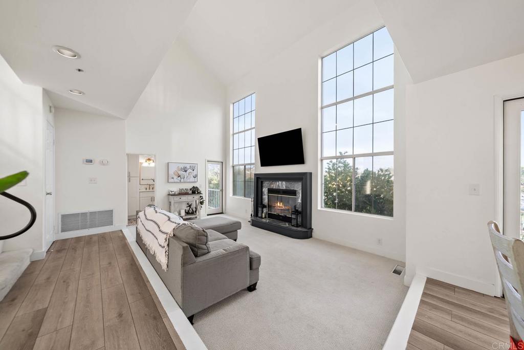 3863 Settineri Lane Spring Valley, CA 91977 - Photo 6 of 39 a living room with furniture a fireplace and a flat screen tv