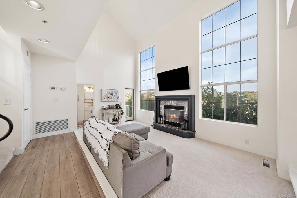 3863 Settineri Lane Spring Valley, CA 91977 - Photo 10 of 39 a living room with furniture a fireplace and a flat screen tv