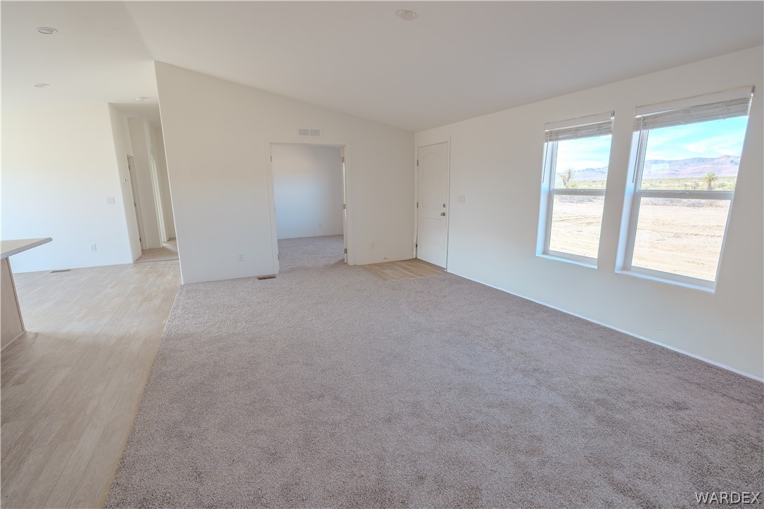 5746 Eden Road Golden Valley, AZ 86413 - Photo 11 of 27 an empty room with windows and closet