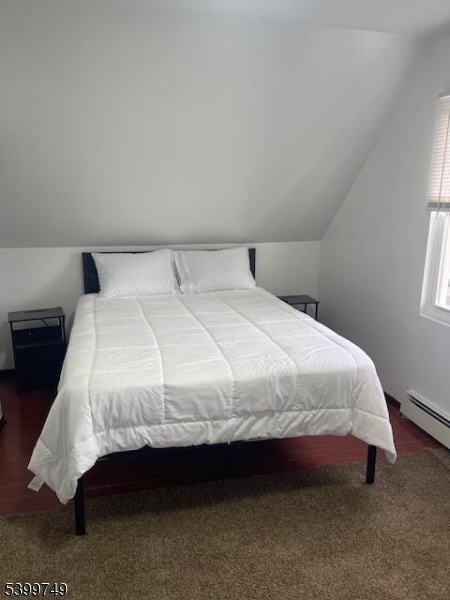 2420 East Edgar Road, Unit 2 Linden, NJ 07036 - Photo 2 of 8 a large bed sitting in a bedroom next to a window