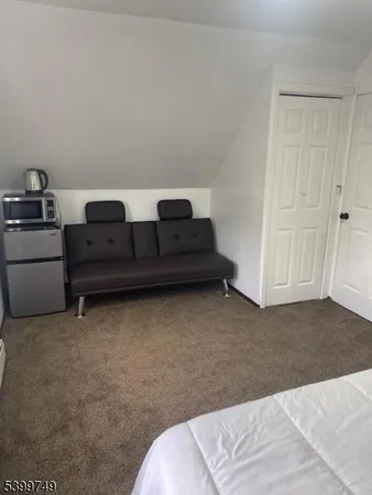 a living room with furniture and a bed