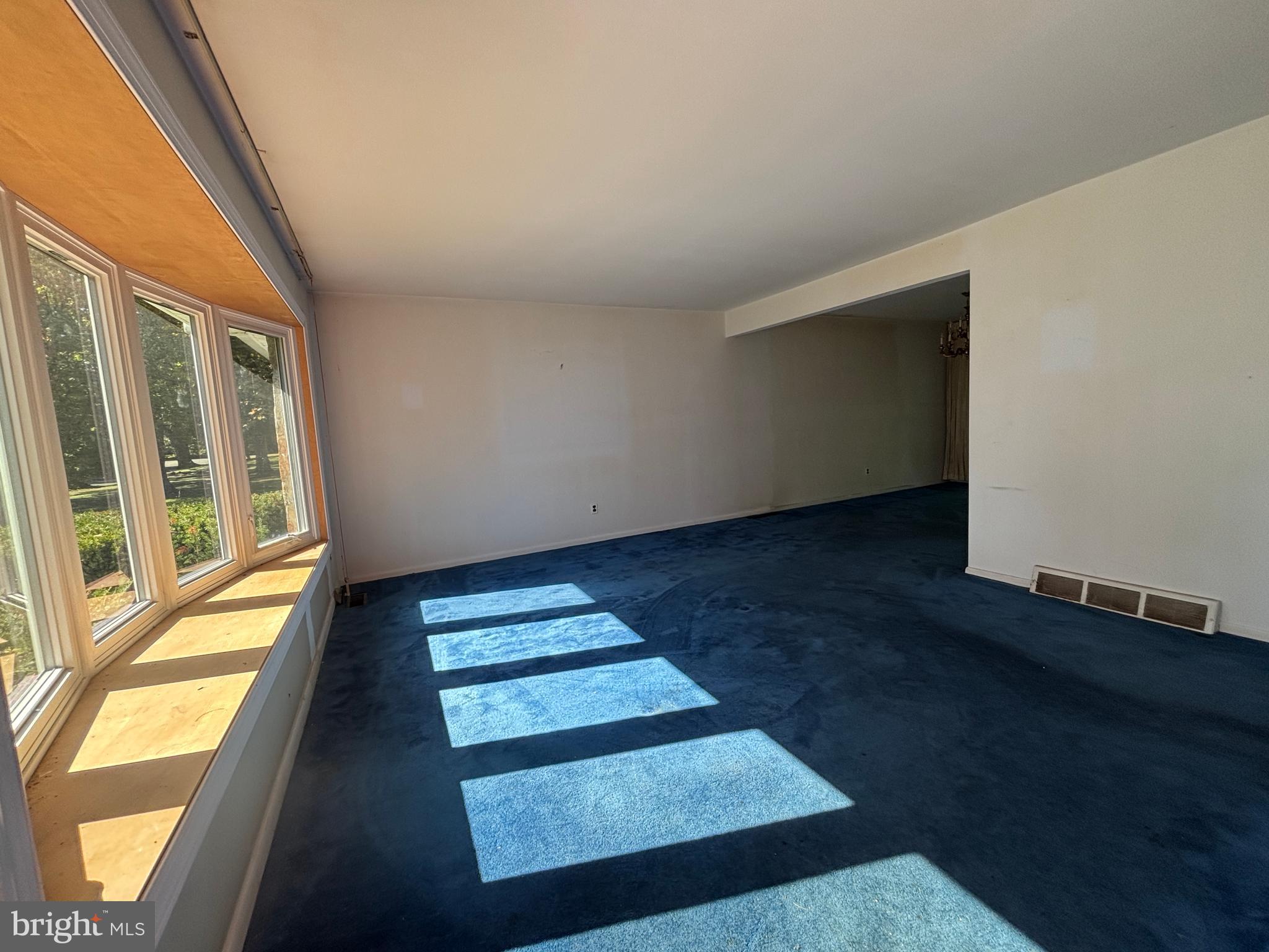 423 Park Boulevard Moorestown, NJ 08057 - Photo 2 of 24 a view of an empty room with wooden floor and a floor to ceiling window