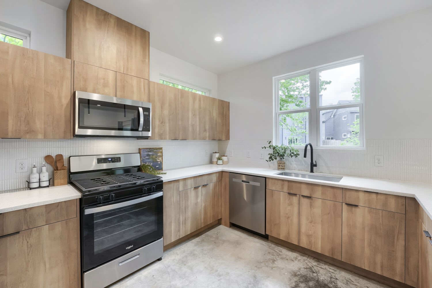 4805 Sara Drive Austin, TX 78721 - Photo 11 of 28 a kitchen with a sink stove and microwave