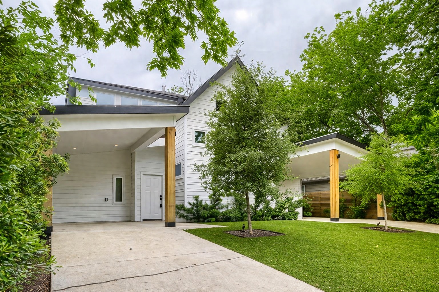 4805 Sara Drive Austin, TX 78721 - Photo 2 of 28 a front view of a house with a yard and trees