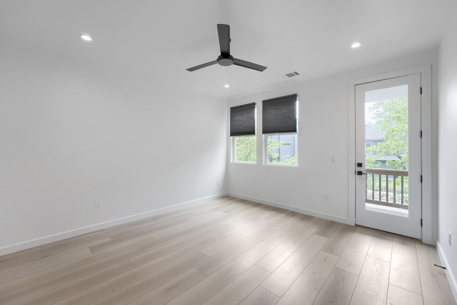 4805 Sara Drive Austin, TX 78721 - Photo 23 of 28 an empty room with wooden floor cabinet and windows