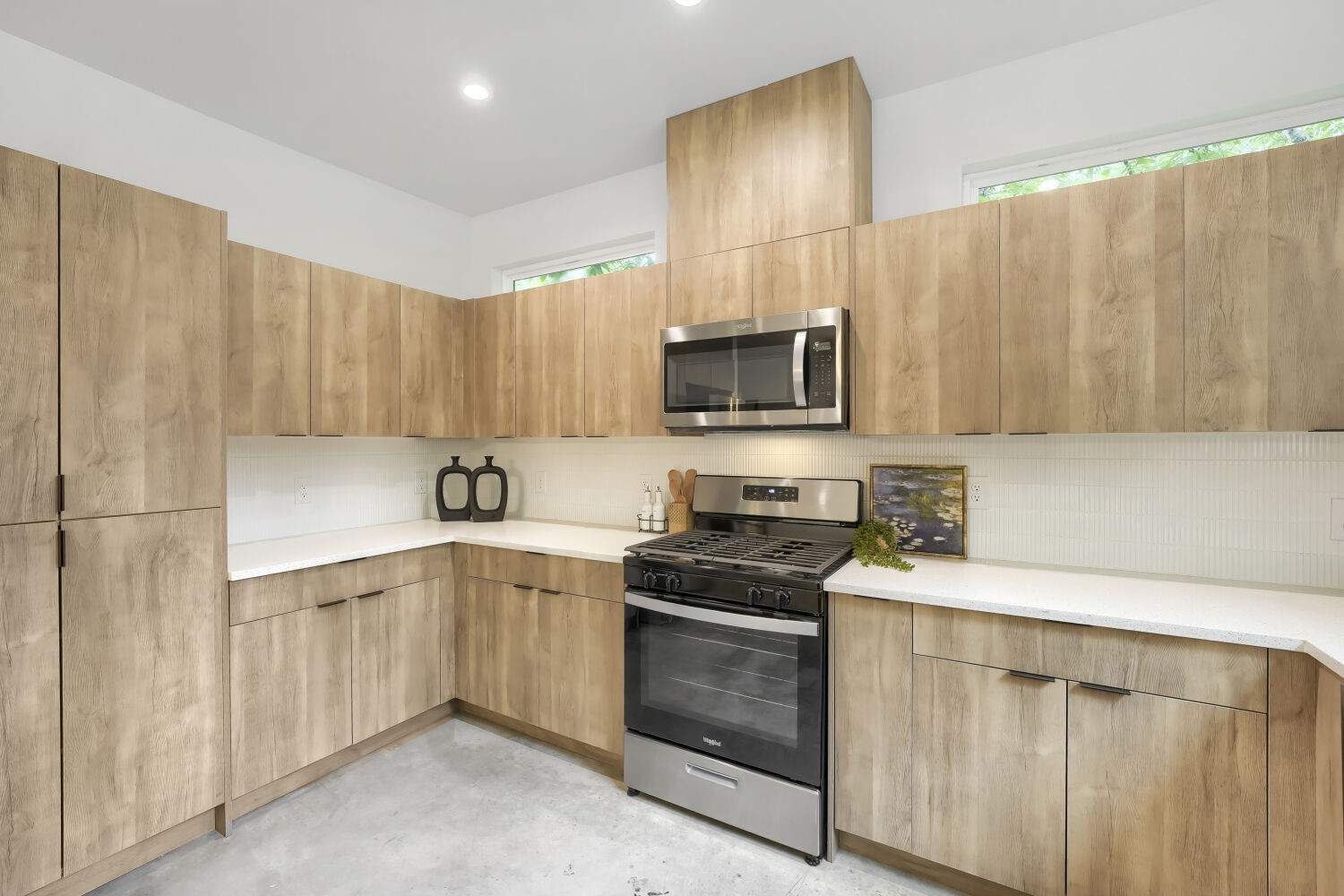4805 Sara Drive Austin, TX 78721 - Photo 10 of 28 a kitchen with stainless steel appliances a stove sink microwave and cabinets