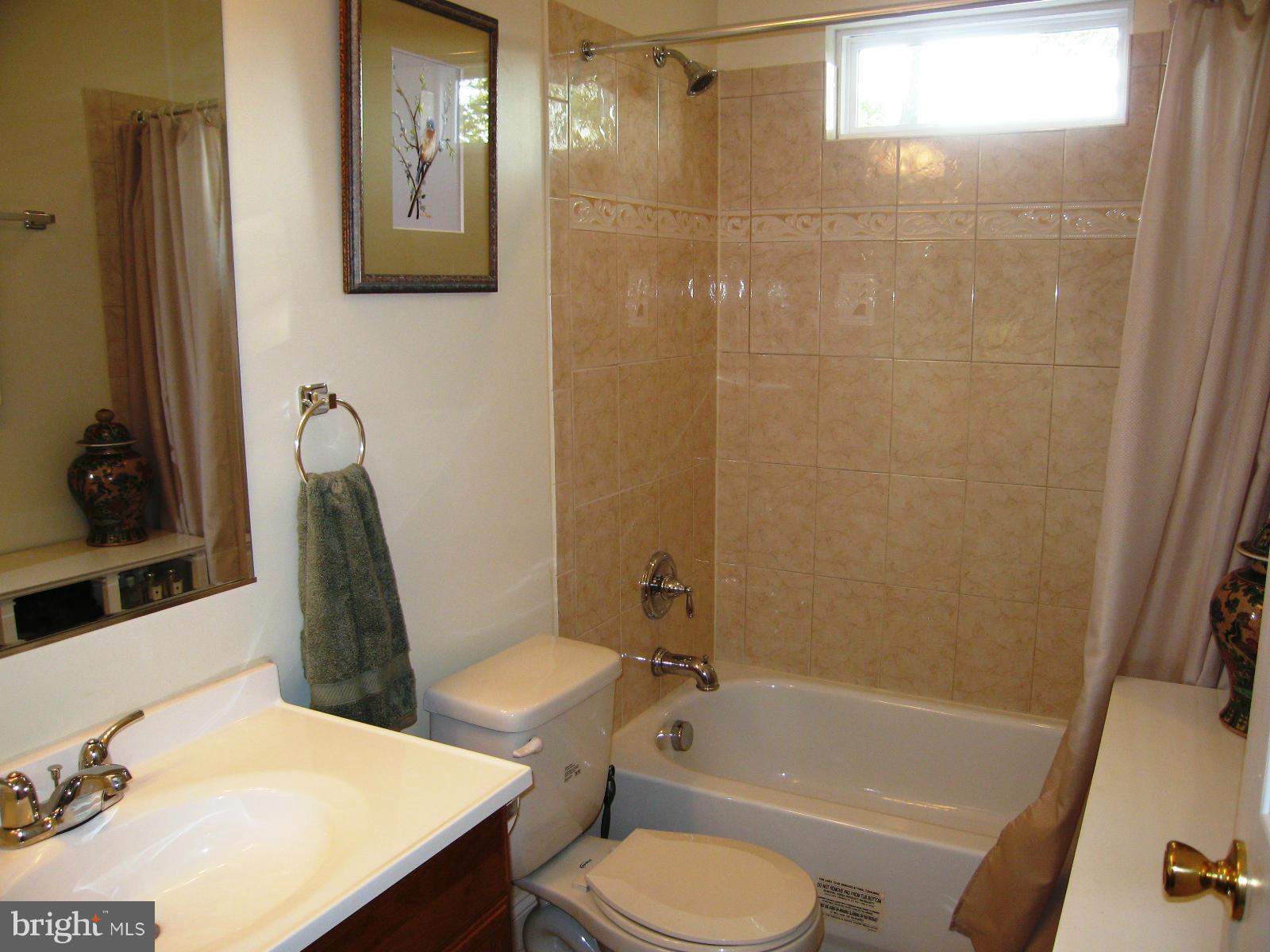 2508 Weisman Road Silver Spring, MD 20902 - Photo 14 of 16 a bathroom with a sink toilet and shower