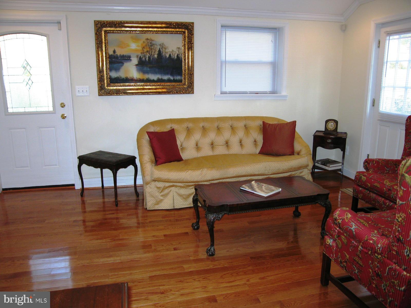 2508 Weisman Road Silver Spring, MD 20902 - Photo 3 of 16 a living room with furniture and a painting on the wall