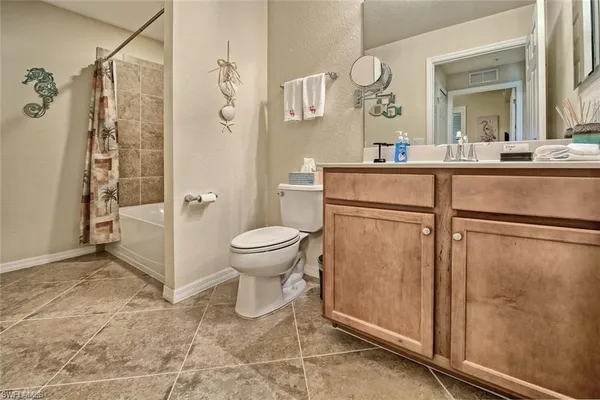 a bathroom with a toilet sink and a mirror