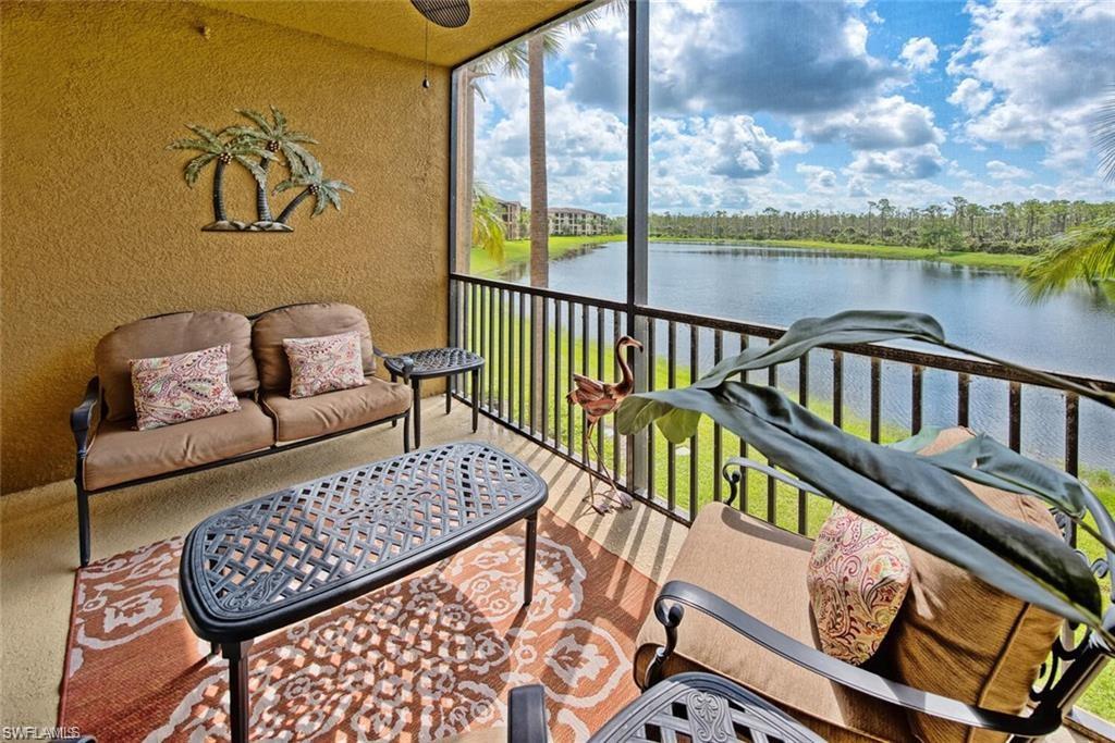 9731 Acqua Court, Unit 525 Naples, FL 34113 - Photo 17 of 35 Sunroom with a water view and plenty of natural light