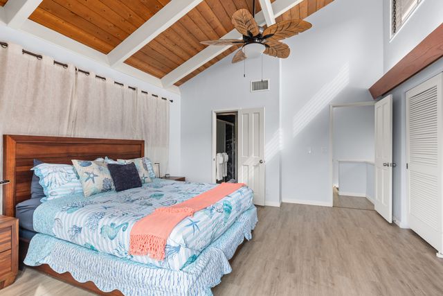 a bedroom with bed and wooden floor