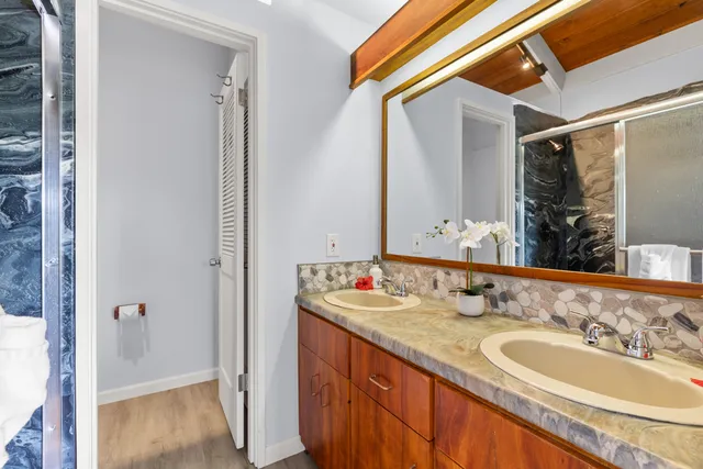 a bathroom with a double vanity sink and a mirror