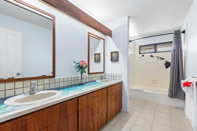 a spacious bathroom with a granite countertop tub sink and mirror