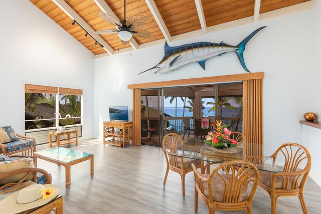 a view of a dining room with furniture a chandelier and wooden floor