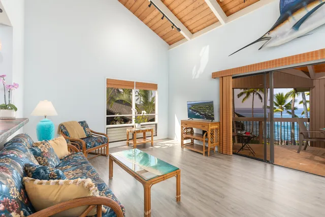 a living room with furniture a fireplace and a floor to ceiling window