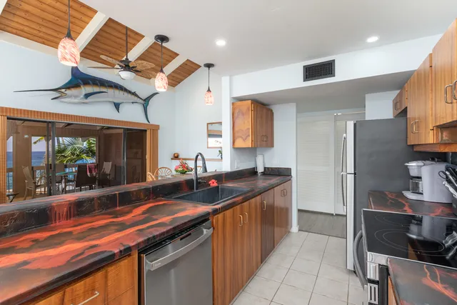 a kitchen with stainless steel appliances granite countertop a sink and cabinets