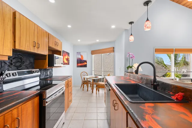 a kitchen with a sink and appliances