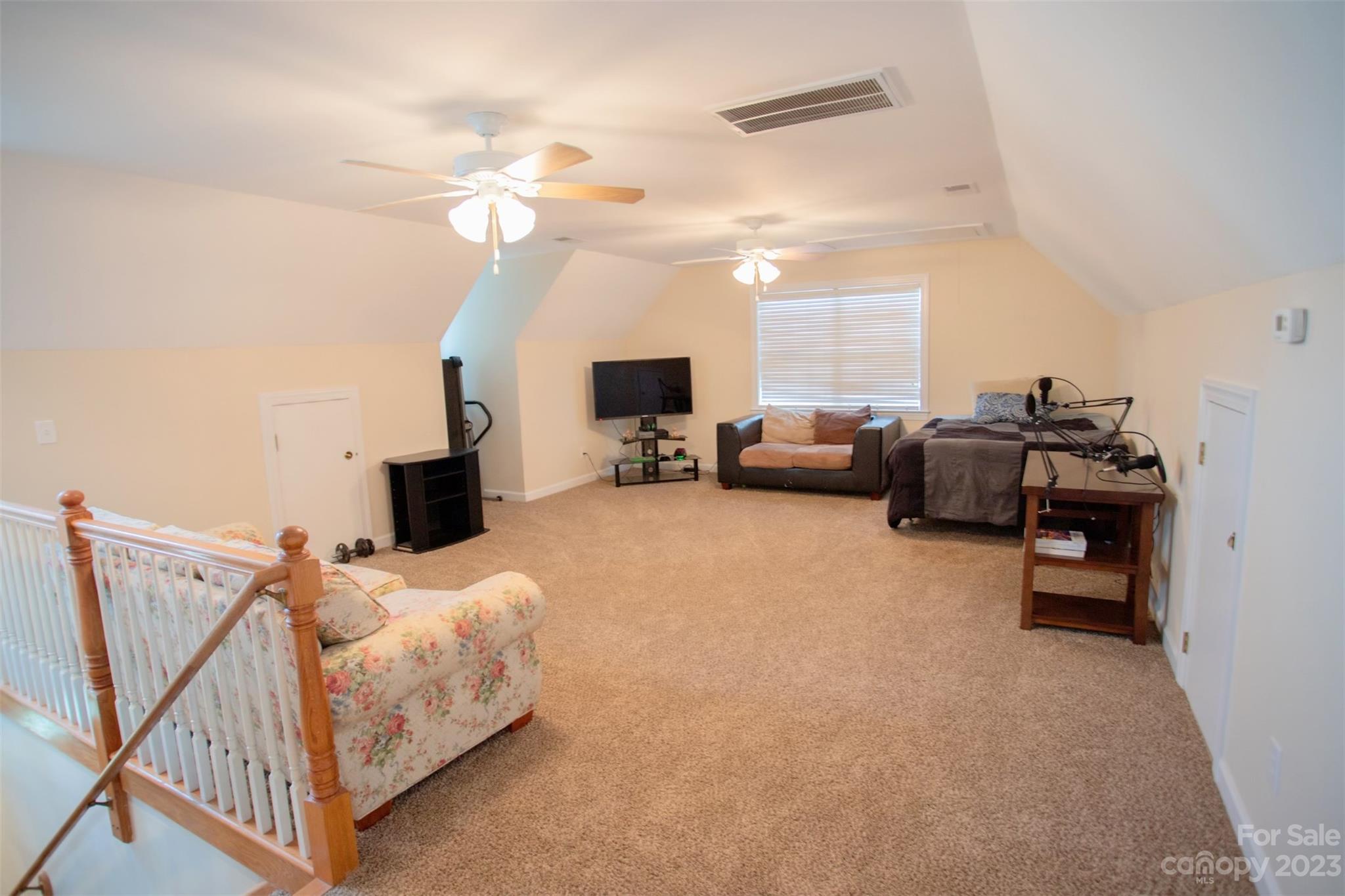 2214 Goldmine Road Monroe, NC 28110 - Photo 17 of 25 a living room with furniture and a chandelier