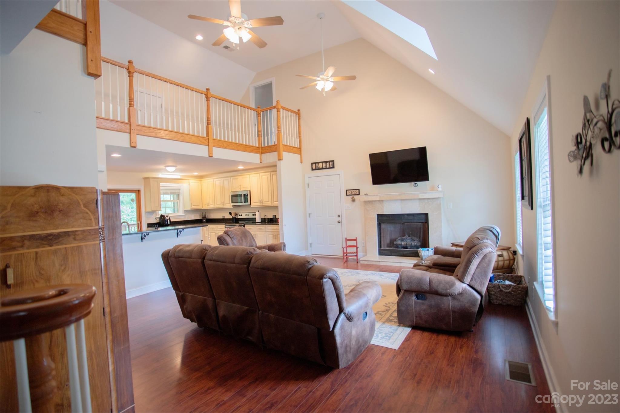 2214 Goldmine Road Monroe, NC 28110 - Photo 3 of 25 a living room with furniture a fireplace a flat screen tv and a fireplace