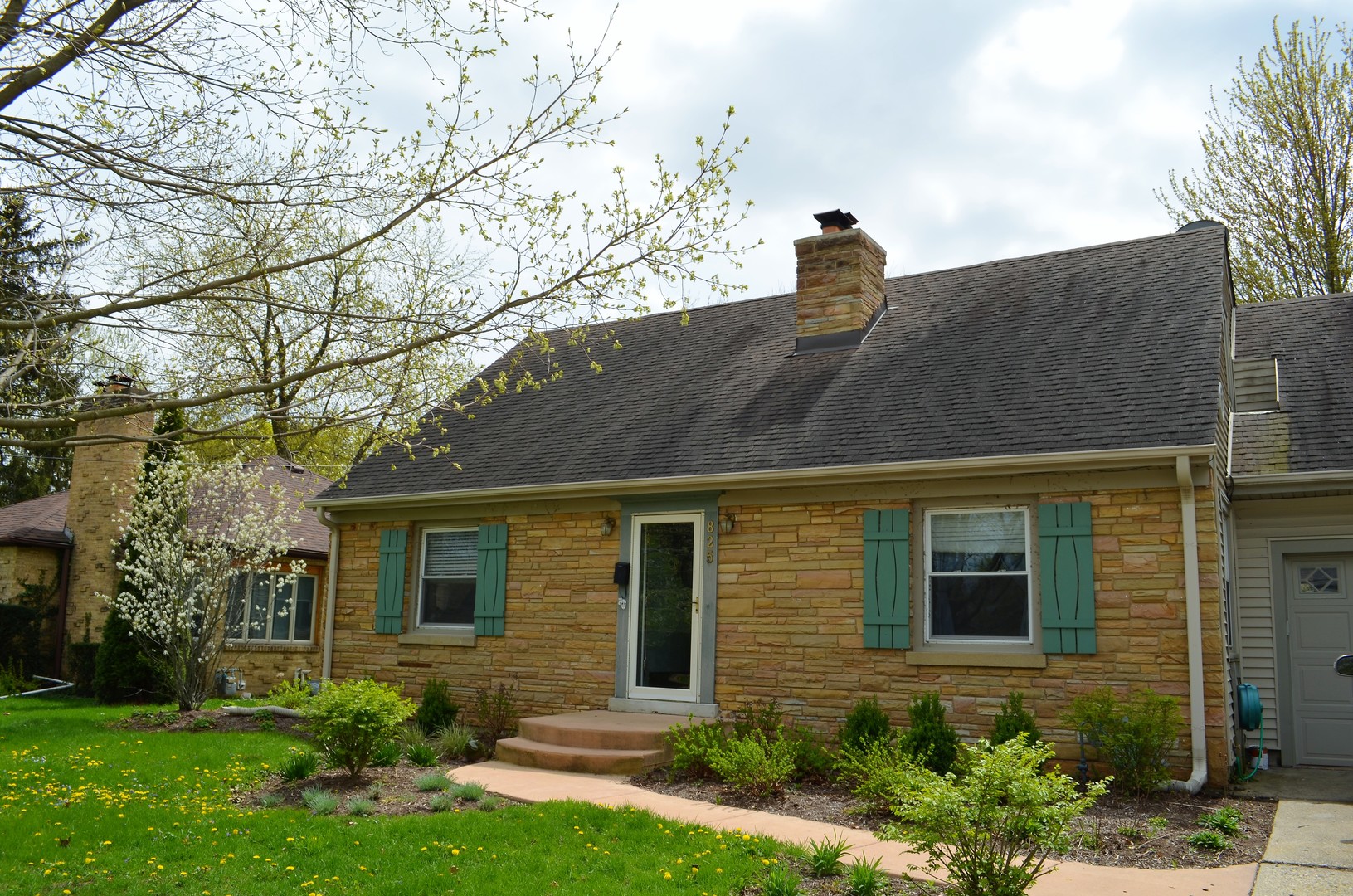 825 Oak Street Elgin, IL 60123 - Photo 1 of 17 a front view of a house with garden