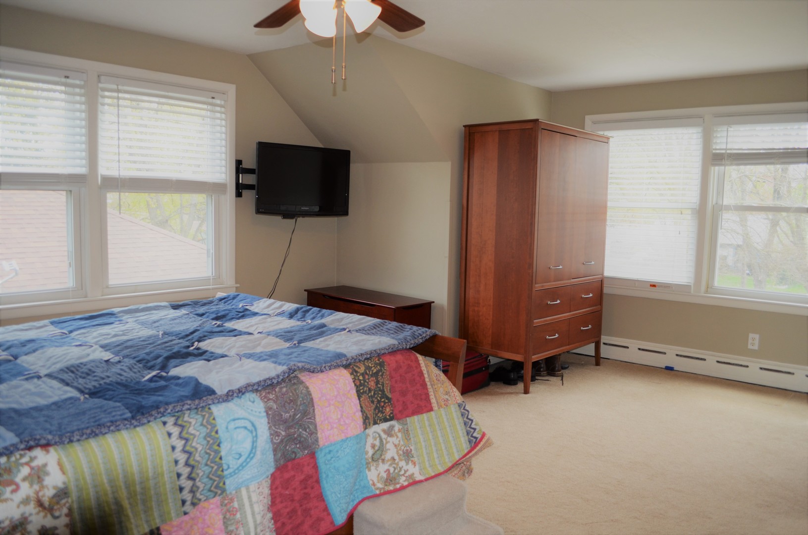 825 Oak Street Elgin, IL 60123 - Photo 8 of 17 a bedroom with a bed and a flat screen tv