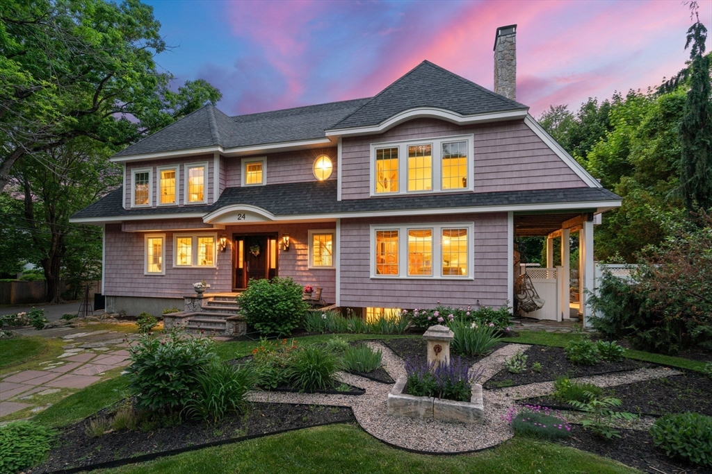 a front view of a house with porch yard and outdoor seating