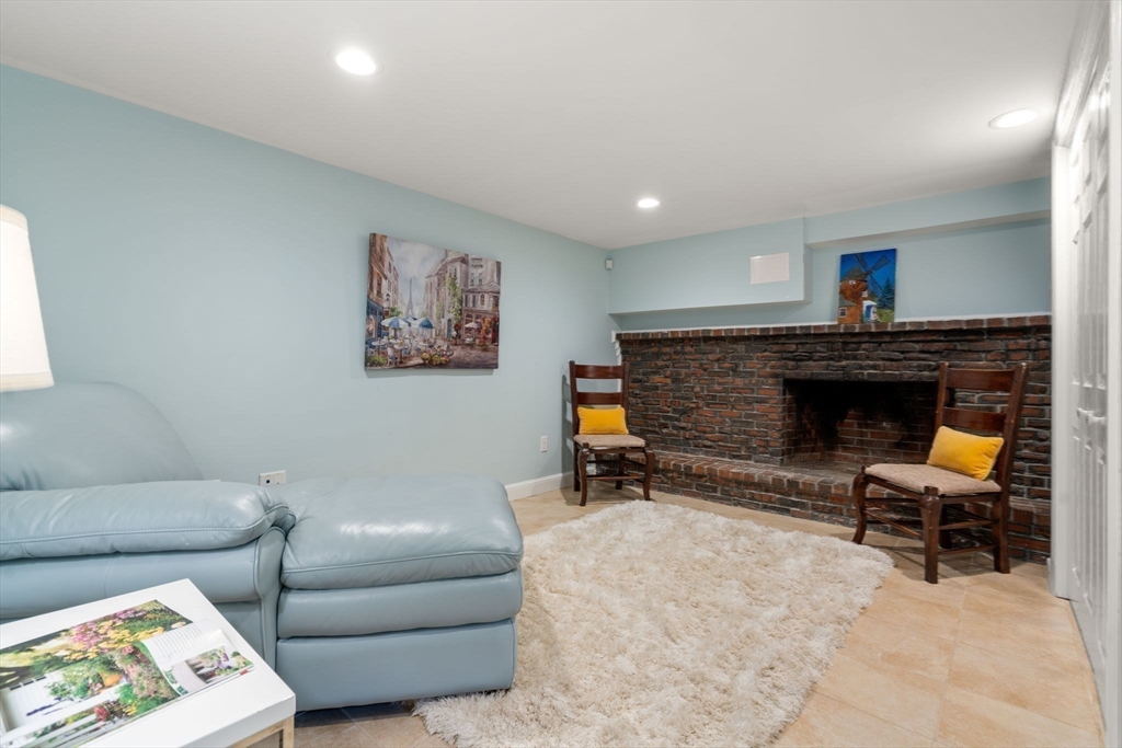 24 Mohawk Road Arlington, MA 02474 - Photo 28 of 42 a living room with furniture and a fireplace