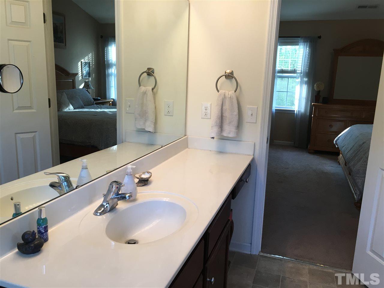 1412 Shady Rise Glen Raleigh, NC 27603 - Photo 14 of 25 Spacious master bath with large windows, lots of natural light, walk-in closet, separate shower and garden tub.