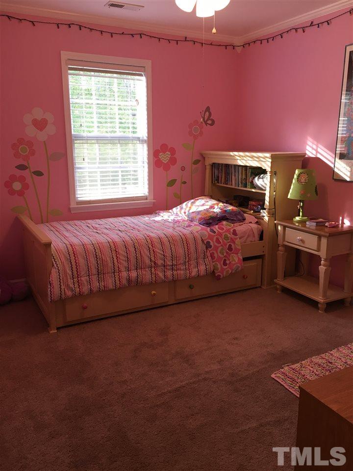1412 Shady Rise Glen Raleigh, NC 27603 - Photo 17 of 25 Secondary bedroom with walk-in closet and ceiling fan.